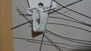 Needles upgrade with fine cotton swatch.  Original bent needles relegated to stitch holders. 